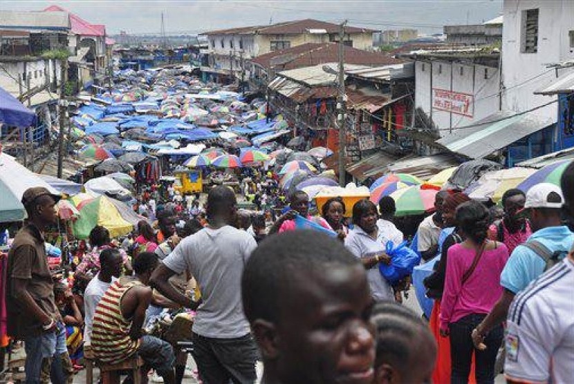 In this Aug. 19, 2014 file photo, people do business at the Waterside local market in the center of Monrovia, Liberia.