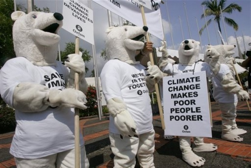 In this Dec. 6, 2007, file photo, Oxfam activists wearing polar bear costumes stage a demonstration outside the venue of the UN climate change conference in Nusa Dua, Bali island, Indonesia. 