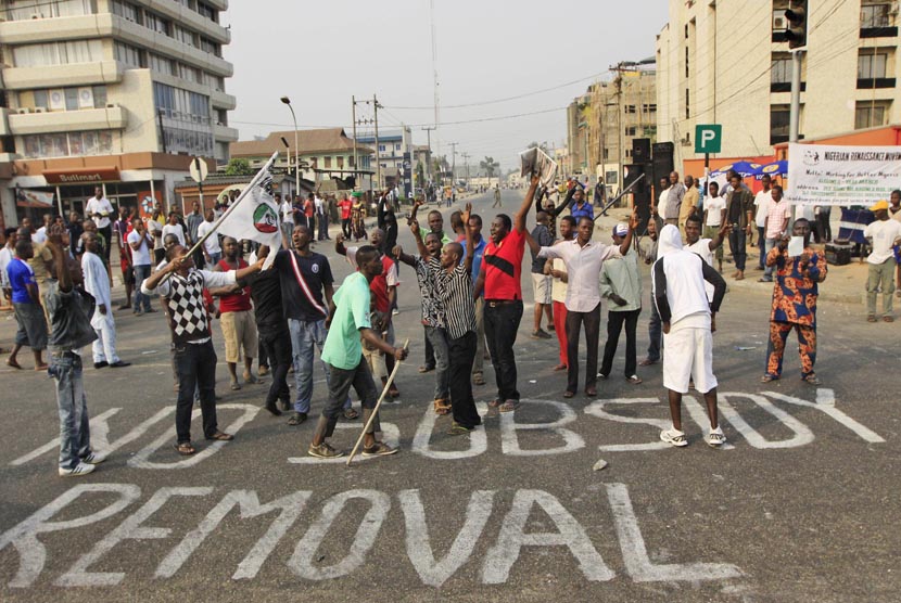 In this Friday, Jan. 13, 2012 file photo, People protest on a sign written on a major road saying' No subsidy removal' in Lagos, Nigeria.