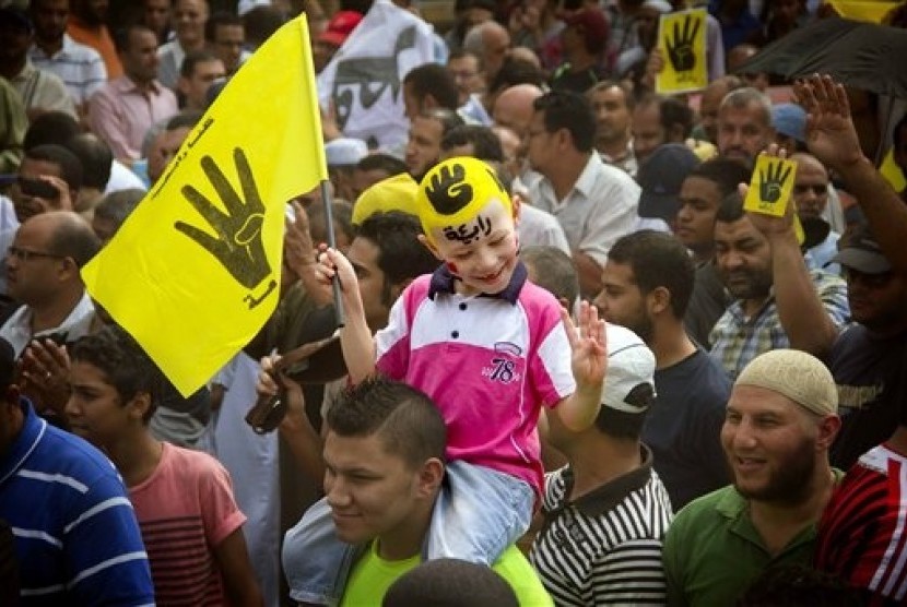 In this Friday, Sept. 27, 2013 file photo, A young Egyptian boy participates in a demonstration by supporters of ousted President Mohammed Morsi in the Maadi district of Cairo, Egypt.