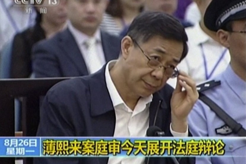 In this image taken from video, former Chinese politician Bo Xilai looks up in a court room at Jinan Intermediate People's Court of Jinan, Shandong, on Monday August 26, 2013. 