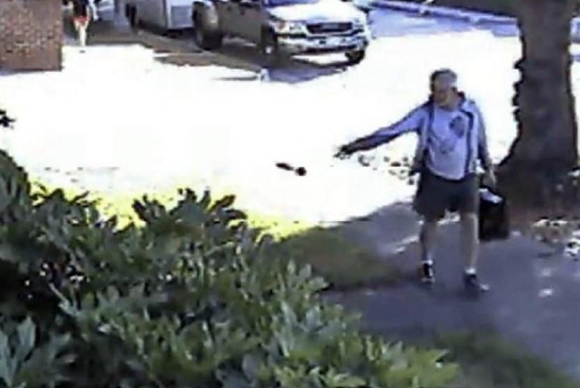 In this June 7, 2014 file image from from a security video provided by Philip Lao, shows Dennis Kneier, the mayor of San Marino, Calif., tosses a bag of dog waste onto the property of his Lao, in San Marino, Calif. 