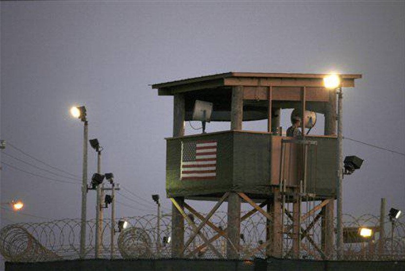 In this March 29, 2010 photo, reviewed by the US military, a Guantanamo guard keeps watch from a tower overlooking the detention facility at Guantanamo Bay US Naval Base, Cuba. 