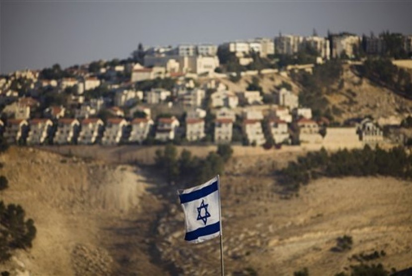 An Israeli flag is seen in front of the West Bank Jewish settlement of Maaleh Adumim on the outskirts of Jerusalem. 