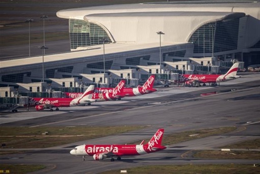 In this Nov 26, 2014 photo, AirAsia Airbus A320-200 passenger jets are seen on the tarmac at low cost terminal KLIA2 in Sepang, Malaysia.
