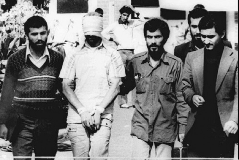 In this Nov. 9, 1979, file photo, one of the hostages were being held at the US Embassy in Tehran is displayed to the crowd, blindfolded and with his hands bound, outside the embassy. (Photo file)