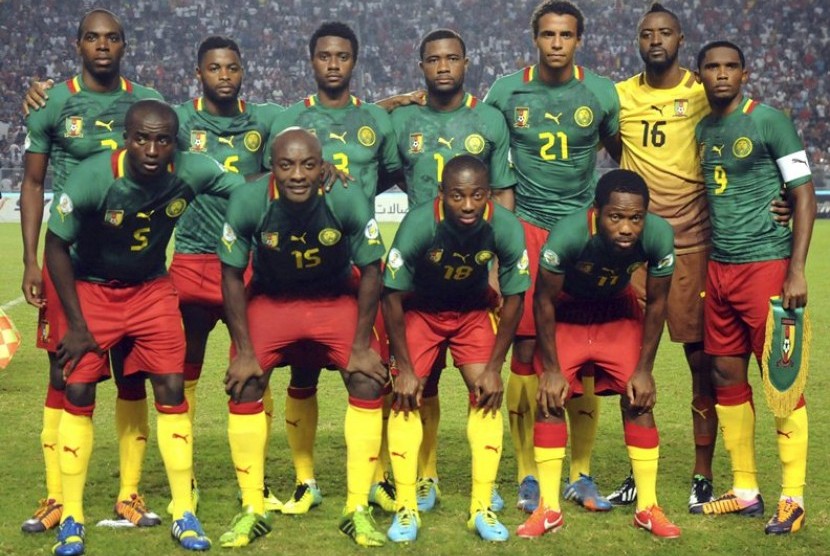 In this Oct. 13, 2013 file photo, Cameroon soccer team poses prior to the start the World Cup qualifying soccer between Tunisia and Cameroon in Tunis, Tunisia. Foreground from left: Tchounko Nounke, Kouamo Webo, Takang Enouh Eyong and Jean Makoun. Backgrou