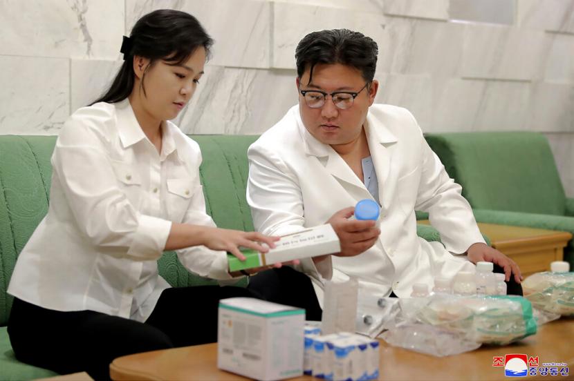 In this photo provided by the North Korean government, North Korean leader Kim Jong Un and his wife Ri Sol Ju prepare medicines at an unannounced place in North Korea Wednesday, June 15, 2022 to send them to Haeju City where an infectious disease occurred.