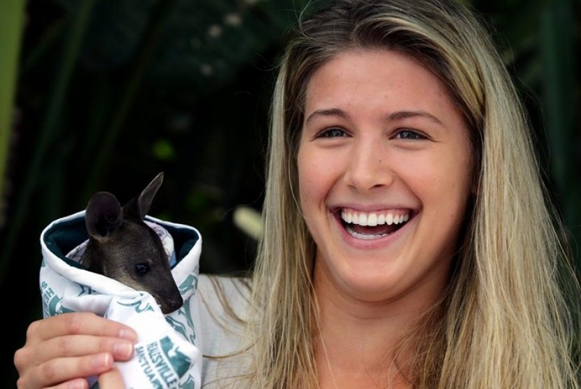 In this photo released by Tennis Australia, Eugenie Bouchard of Canada holds a baby wwallaby in the players lounge at the Australian Open tennis championship in Melbourne, Australia, Wednesday, Jan. 22, 2014. Bouchard will play China's Li Na in a semifinal