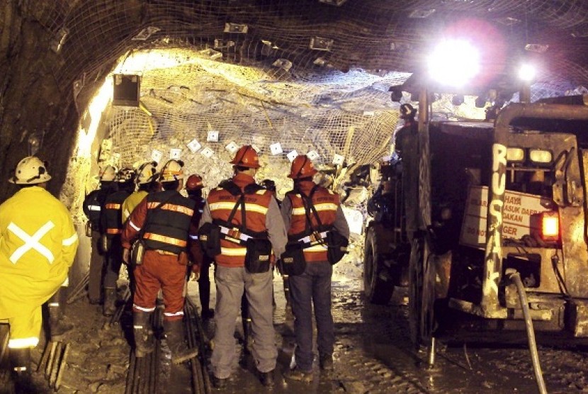 In this photo taken and released by PT Freeport Indonesia, on May 17, 2013, the Indonesian unit of Arizona-based Freeport-McMoRan Copper & Gold Inc, rescuers gather inside a tunnel that collapsed in May.