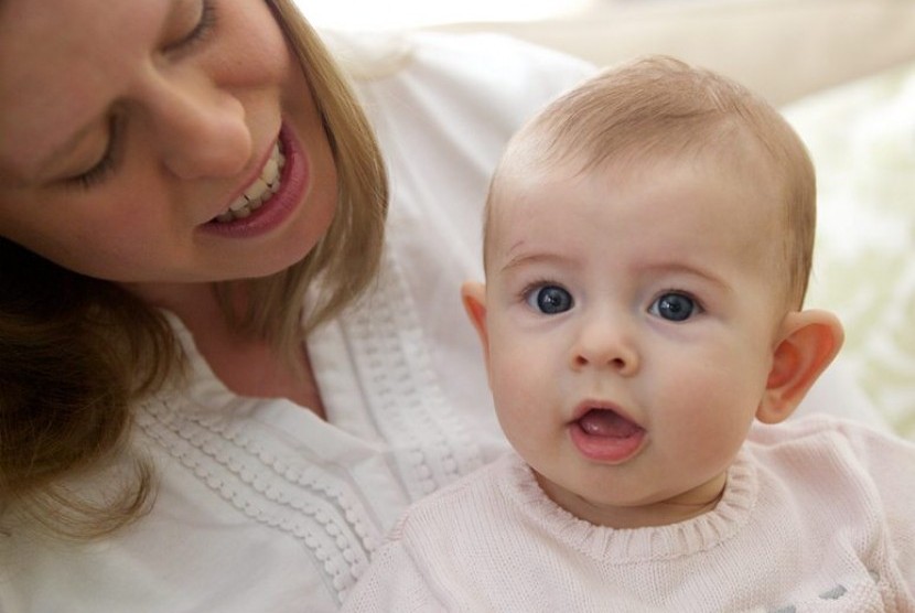 In this photo taken Sept. 24, 2013, Holly Sloan interacts with her baby Amelia at their home in Warrenton, Va. Ameliaís family enrolled in a study that is deciding the DNA of babies, as researchers explore whether gene-mapping one day should become a part 