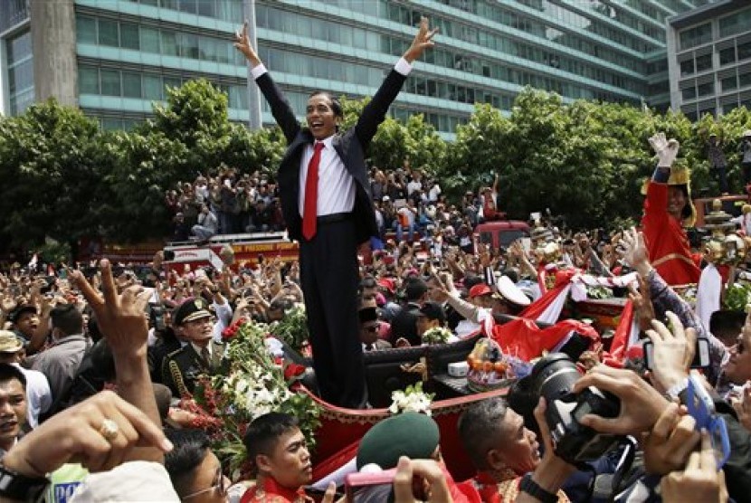 Indonesian President Joko Widodo gestures to the crowd during a street parade following his inauguration in Jakarta, Indonesia, Monday, Oct. 20, 2014. 