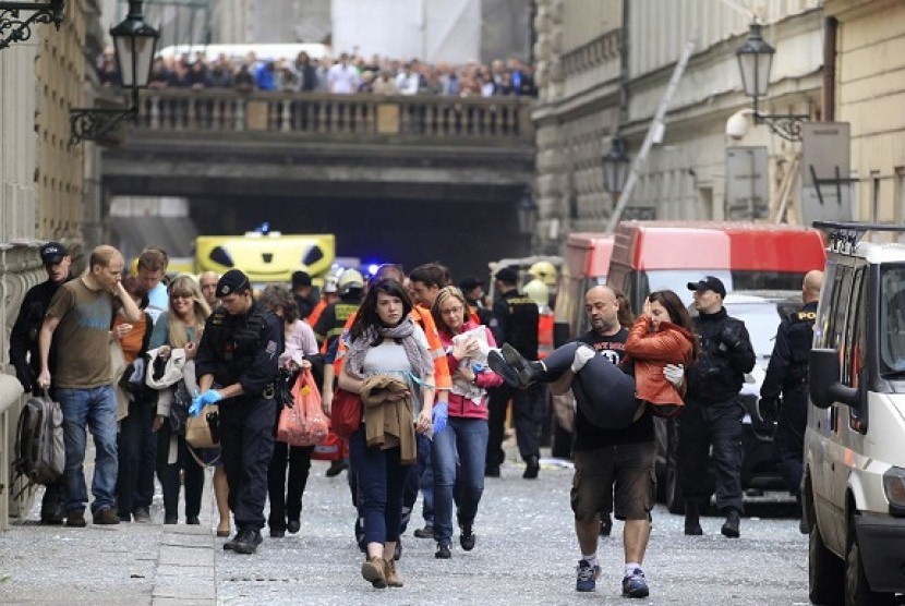Injured people leave a scene of an explosion in downtown Prague, Czech Republic, Monday, April 29, 2013. 