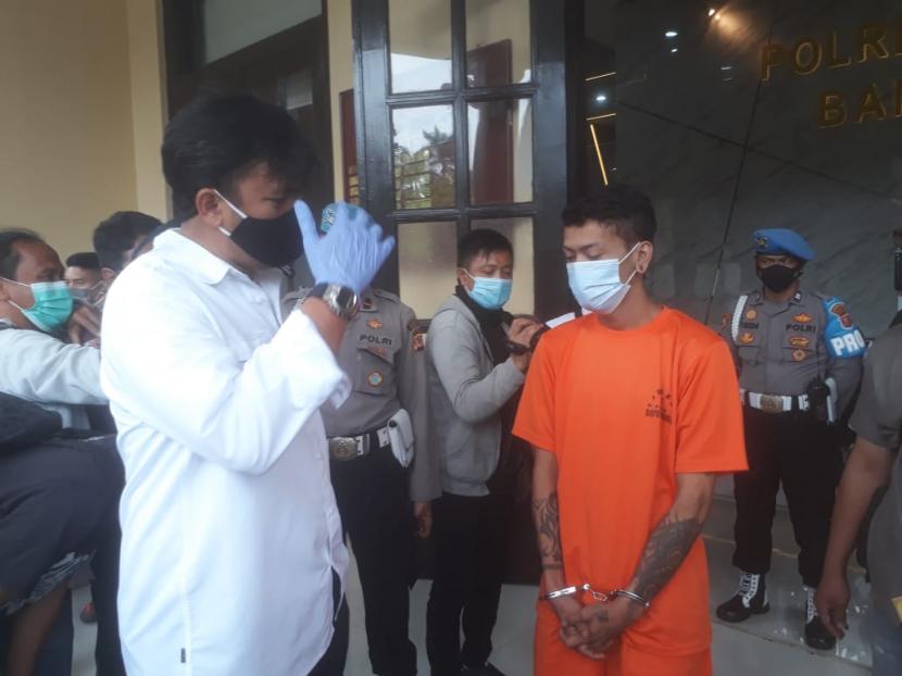 Tersangka kasus penganiayaan, IM (baju oranye), di Markas Polrestabes Bandung, Senin (15/2/2021). 