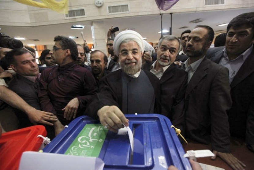 Iranian presidential candidate Hasan Rohani, the country's former top nuclear negotiator, casts his ballot in the presidential election at a polling station in downtown Tehran, Iran, Friday, June 14, 2013. 