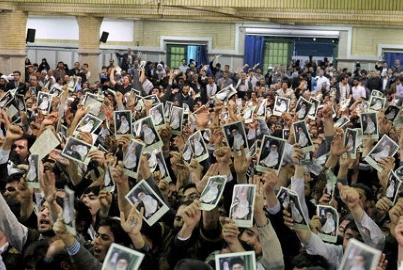 Iranian well wishers attending the speech of Supreme Leader Ayatollah Ali Khamenei hold up his picture at a mosque inside the leader's housing compound in Tehran, Iran, Saturday.
