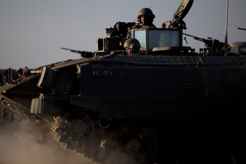 Israeli soldiers ride on top of an armored personal carrier close to the Israel Gaza Border, southern Israel, Thursday, Nov. 15, 2012. Israel's prime minister says the army is prepared for a 