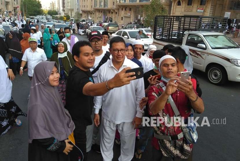 Jamaah haji Indonesia berswafoto dengan Menteri Agama Lukman Saifuddin di Makkah, Jumat (17/8). Sebagian jamaah tersebut juga mengajak Menag menyanyikan lagu Indonesia raya.