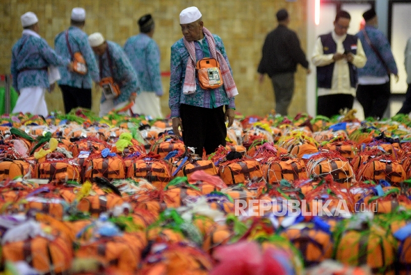   Jamaah Haji Indonesia Kloter Pertama Debarkasi Jakarta Pondok Gede (JKG) mengecek koper bawaan tiba di Asrama Haji Pondok Gede, Jakarta, Kamis (7/9). 