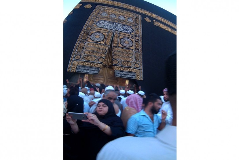 Jamaah umrah tengah selfie di depan Kabah.