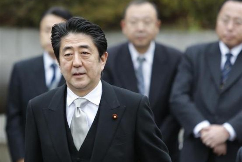 Japan's Prime Minister Shinzo Abe arrives at the controversial Yasukuni Shrine to pay tribute to the war dead, in Tokyo December 26, 2013.