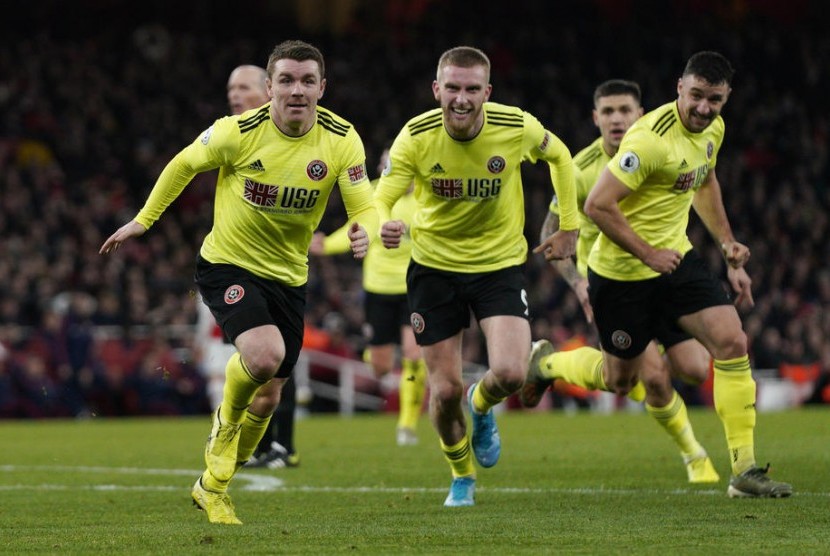 John Fleck melakukan selebrasi usai mencetak gol ke gawang Arsenal.