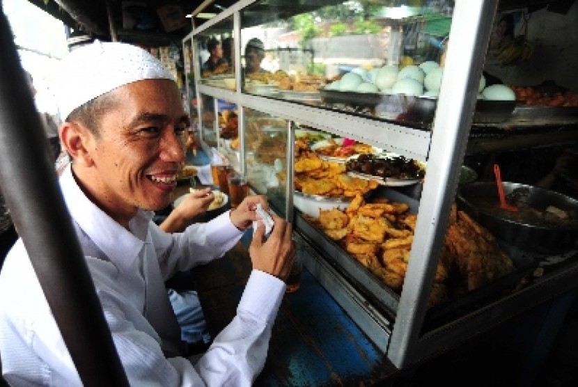 Jokowi berbaur dengan masyarakat menikmati makan siang seusai menunaikan ibadah shalat Jumat di Masjid Agung Sunda Kelapa, Jakarta Pusat, Jumat (6/4).
