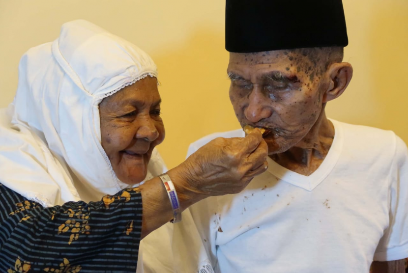 Kakek Mahmud (82 tahun; kanan), jamaah haji asal Maluku yang tak mau dipisahkan dengan istrinya, Nenek Cum (75).