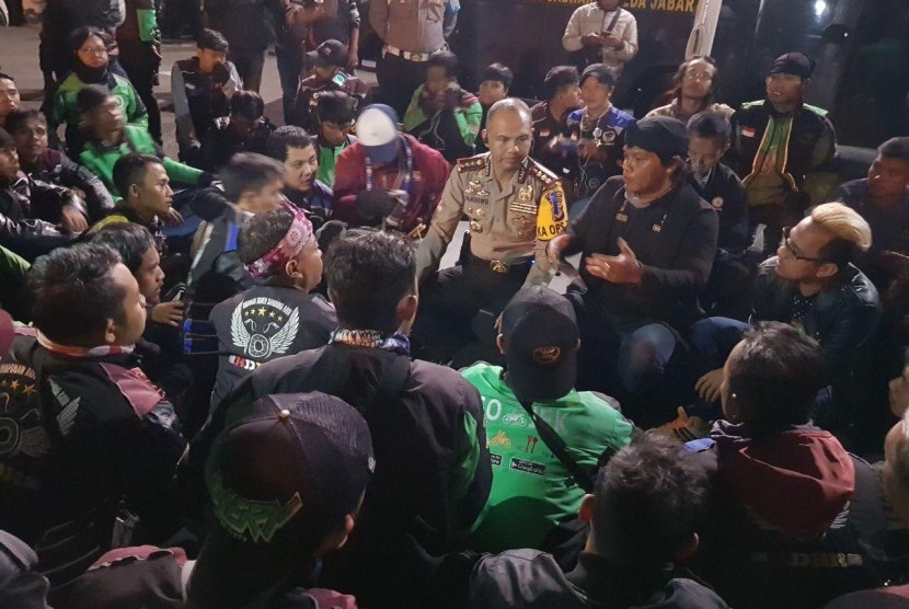 Kapolrestabes Bandung Kombes Pol Hendro Pandowo berdialog dengan ratusan pengemudi ojek online di halaman Mapolrestabes Bandung. Mereka mendesak polisi mengusut tuntas kasus penusukan rekan mereka, Selasa (26/12).