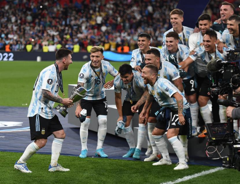 Kapten Argentina Lionel Messi (kiri) membawa trofi Finalissima setelah mengalahkan Italia 3-0.