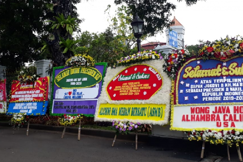 Karangan bunga ucapan selamat kepada paslon Jokowi-Ma'ruf tampak berjejer di halaman pintu masuk Istana Presiden, Jakarta, Senin (22/4). 