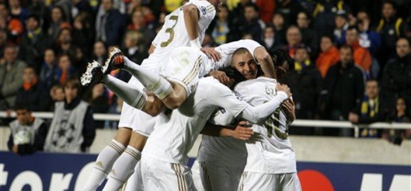  Karim Benzema (dua kanan), striker Real Madrid, merayakan golnya bersama rekan setim saat menghadapi APOEL Nicosia di leg pertama babak perempat final Liga Champions di Stadion GSP, Nicosia, Selasa (27/3).