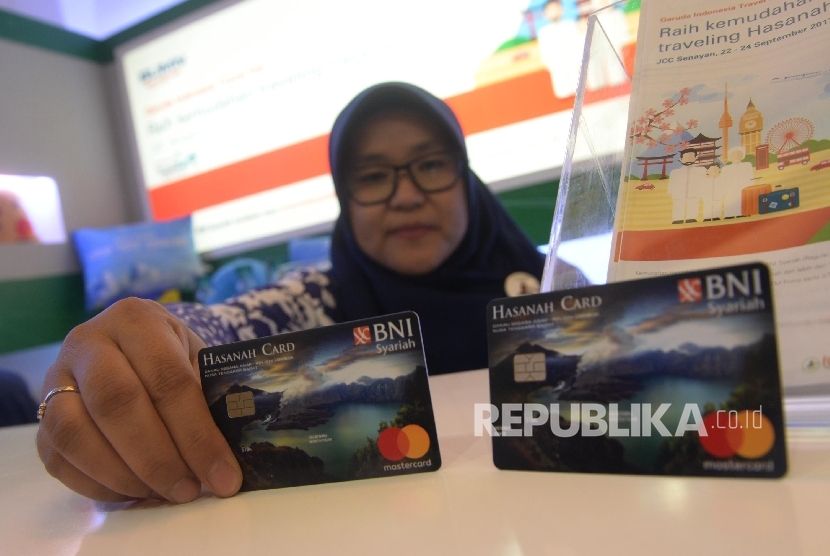 Karyawan menunjukkan Kartu BNI IB Hasanah Card spesial desain Lombok saat peluncuran, Jakarta, Jumat (22/9).