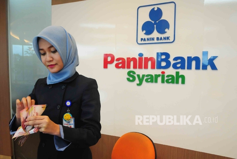 Karyawati menghitung uang di Banking Hall Bank Panin Syariah Jakarta.  (Republika/Agung Supriyanto)