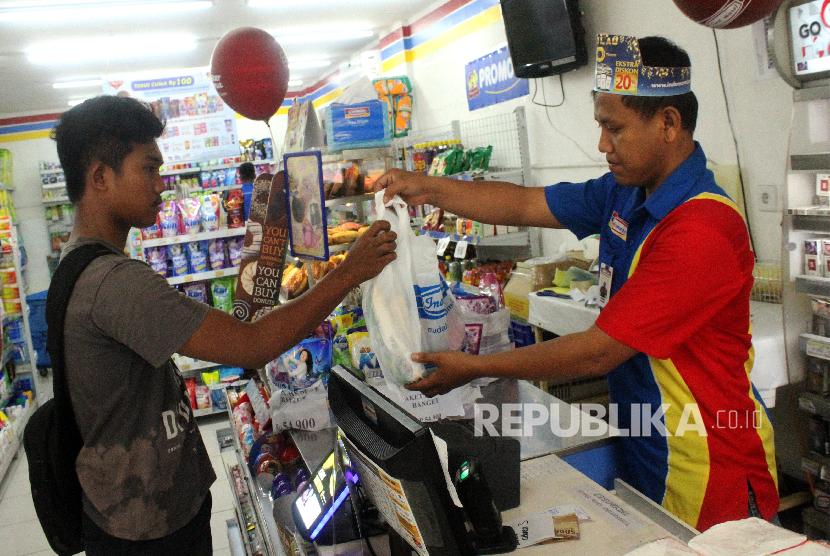 Kasir melayani konsumen berbelanja kebutuhan menggunakan kantong plastik di salah satu toko ritel, di Bekasi, Jawa Barat, Selasa (11/12). Sektor ritel bisa menjadi motor pemulihan ekonomi nasional.
