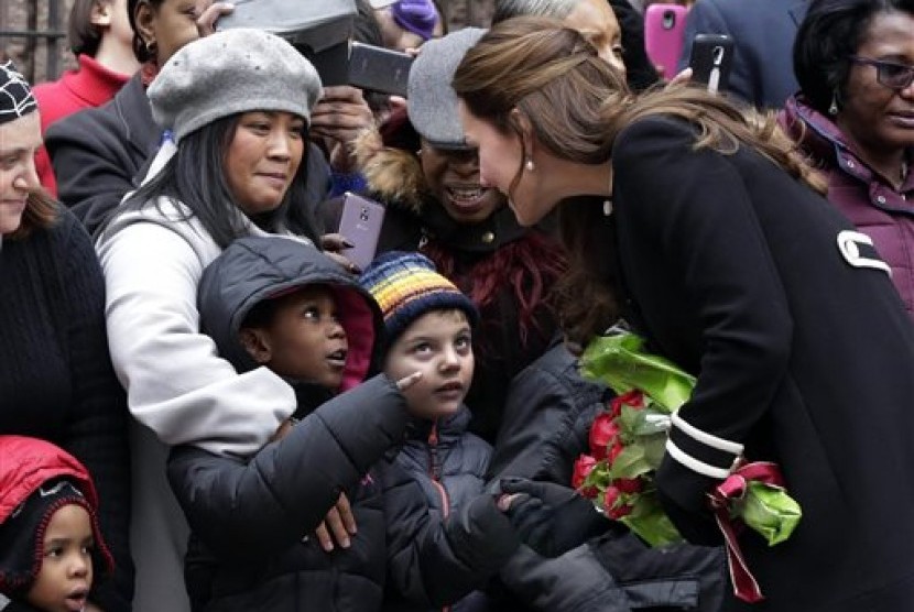 Kate, Duchess of Cambridge (right) greets children and parents outside the Northside Center after her visit, in New York, Monday, Dec. 8, 2014. 