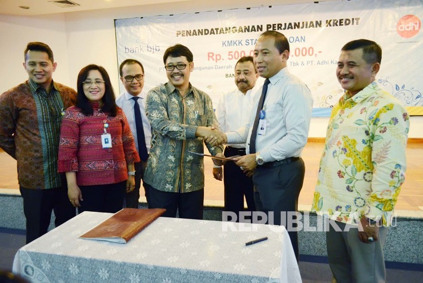 Kedua belah pihak saling memegang lembar Perjanjian Kerjasama Sama (PKS) usai melakukan penandatanganan PKS pemberian kredit infrastruktur dari Bank BJB sebesar Rp 500 Miliar kepada PT Adhi Karya (Persero), di Menara Bank BJB, Kota Bandung, Rabu (6/4)