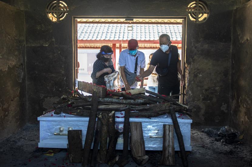 Keluarga menaburkan bunga di atas peti jenazah yang akan dikremasi dengan pemulasaraan COVID-19 di Krematorium Cilincing, Jakarta Utara, Ahad (25/7/2021). Berdasarkan data Satgas Penanganan COVID-19, jumlah kasus meninggal dunia akibat paparan COVID-19 bertambah sebanyak 1.266 orang sehingga total korban jiwa di Indonesia sebanyak 83.279 orang.