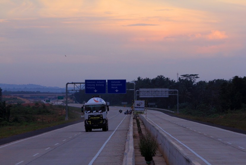 Kendaraan melintas di lokasi pembangunan Jalan Tol Trans Sumatera Seksi II Ruas Sidomulyo-Kota Baru di Desa Sabah Balau, Lampung Selatan, Lampung, Minggu (16/4). 