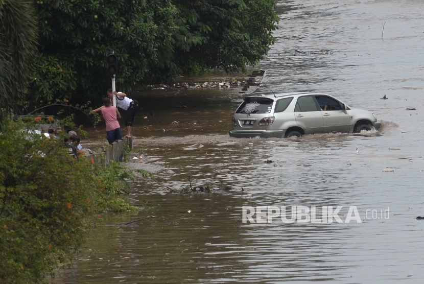 Kendaraan melintasi banjir yang menggenangi jalan menuju pintu tol jatibening dan sebagian jalan tol di sekitar Jati Bening, Bekasi, Jabar,