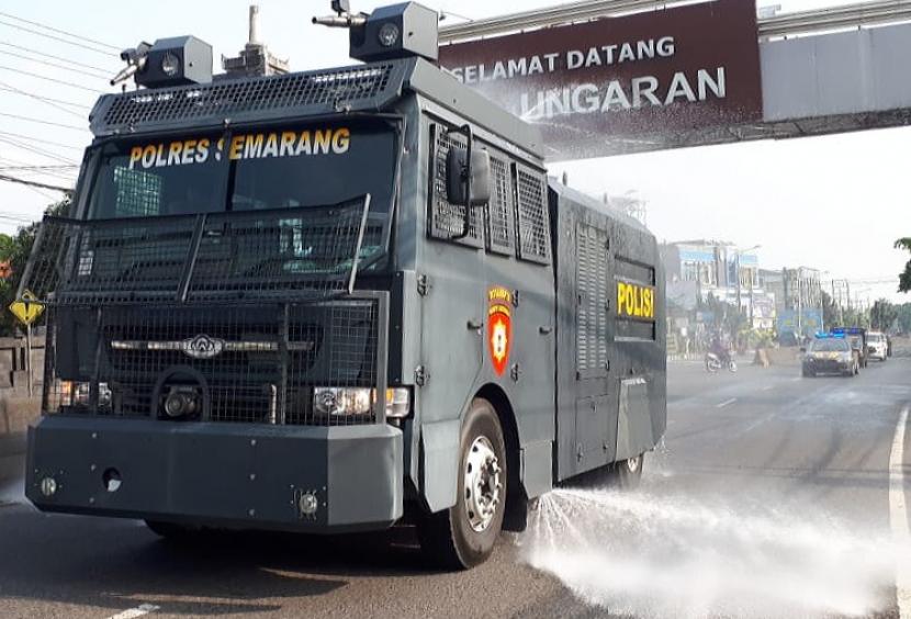 Kendaraan watercannon Polres Semarang melaksanakan disinveksi jalan protokol di kota Ungaran, Kabupaten Semarang, Kamis (10/6). Disinveksi jalan protokol ini menjadi salah satu upaya untuk menekan angka pertambahan kasus baru Covid-19 yang masih berlanjut di daerah tersebut.
