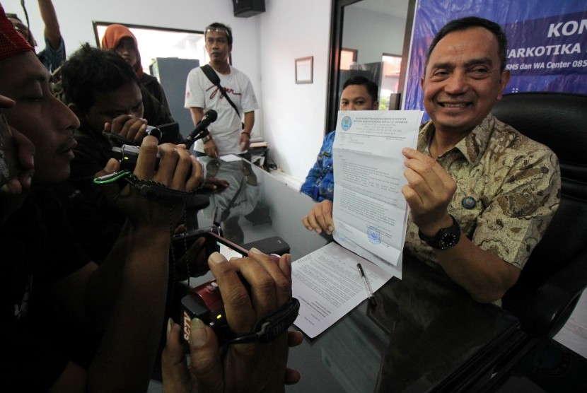 Kepala Badan Narkotika (BNN) Propinsi Jawa Timur Brigjen Pol Fatkhur Rahman (kanan) menunjukkan hasil pemeriksaan sampel 'permen dot' di Kantor BNNP Jawa timur, Surabaya, Jawa Timur, Jumat (10/3). 