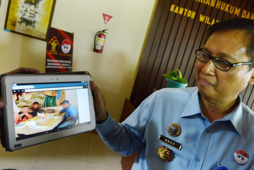 Kepala Divisi Pemasyarakatan Kanwil Kemenkumham Jabar, Agus Toyib memperlihatkan foto aktivitas Gayus Tambunan di luar penjara pada konferesi pers tengtang kasus tersebut, di Kantor Kanwil Kemenkumham Jabar, Kota Bandung, Senin (21/9)