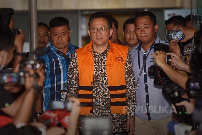 Ketua DPD Irman Gusman (kiri) keluar dari gedung KPK dengan mengenakan rompi tahanan KPK seusai diperiksa penyidik terkait kasus dugaan suap kuota impor gula, Jakarta, Sabtu (17/9)