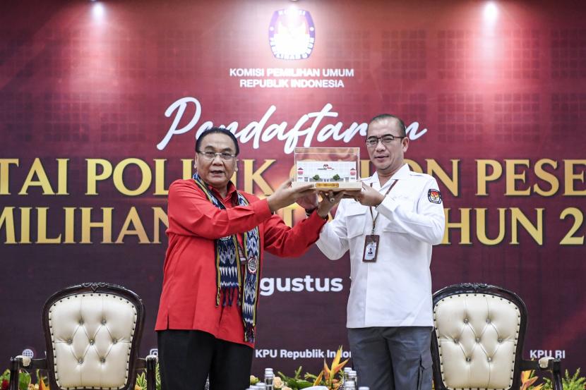 Ketua Komisi Pemilihan Umum (KPU) Hasyim Asy'ari (kanan) memberikan cenderamata kepada Ketua DPP PDI Perjuangan Bidang Pemenangan Pemilu Bambang Wuryanto (kiri) saat Pendaftaran partai politik calon peserta Pemilu 2024 di Kantor KPU, Jakarta, Senin (1/8/2022).