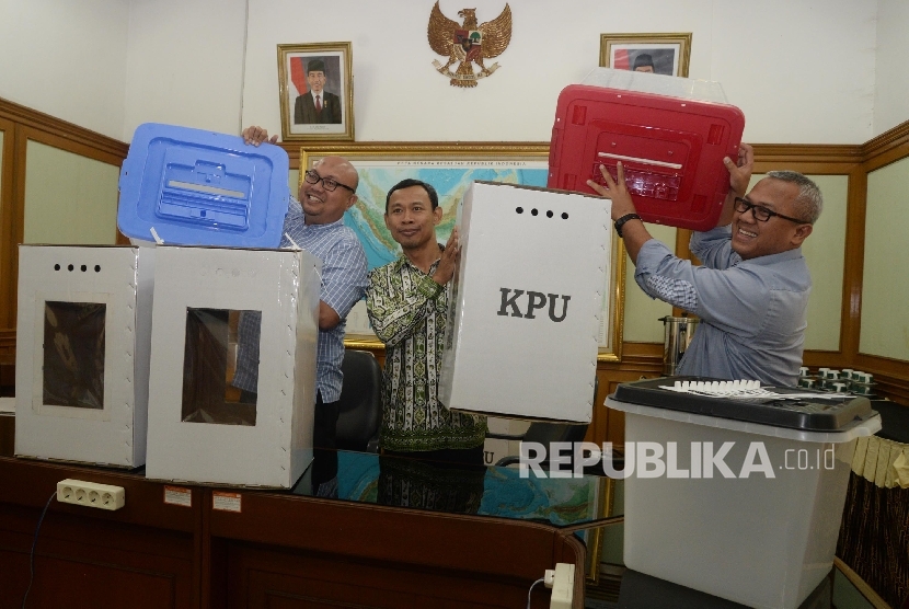 Ketua KPU Arief Budiman (kanan), bersama anggota KPU Pramono Ubaid Tanthowi (tengah), dan Ilham Saputra (kiri) menunjukkan contoh alternatif bentuk kotak suara transparan terbuat dari kertas karton dan Box plastik akan digunakan dalam Pilkada serentak 2018 (ilustrasi)