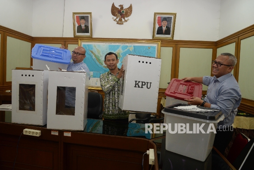 Ketua KPU Arief Budiman (kanan), bersama anggota KPU Pramono Ubaid Tanthowi (tengah), dan Ilham Saputra (kiri) menunjukkan contoh alternatif bentuk kotak suara transparan terbuat dari kertas karton dan Box plastik akan digunakan dalam Pilkada serentak 2018 dan Pemilu 2019 di kantor KPU, Jakarta, Senin (7/8).