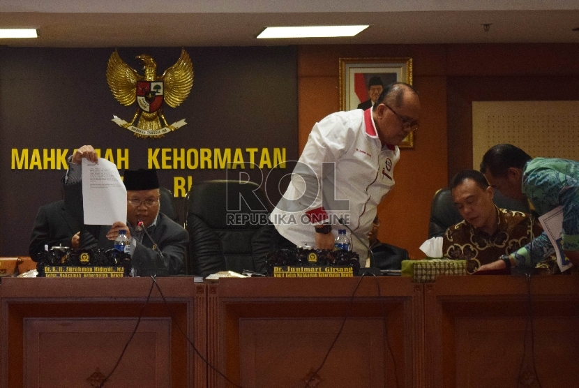   Ketua Mahkamah Kehormatan Dewan (MKD) Surahman Hidayat (kiri) menunjukkan surat keputusan sidang MKD terkait dugaan pelanggaran etiknya di Kompleks Parlemen Senayan, Jakarta, Rabu (16/12). (Republika/Rakhmawaty La'lang)