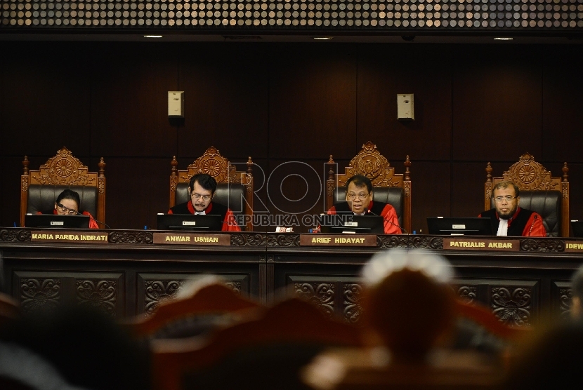 Ketua Sidang Mahkamah Konstitusi Arief Hidayat (keempat kiri) membacakan putusan sidang atas gugatan UU Otoritas Jasa Keuangan (OJK) di Mahkamah Konstitusi, Jakarta, Selasa (4/8).     (Republika/Raisan Al Farisi)