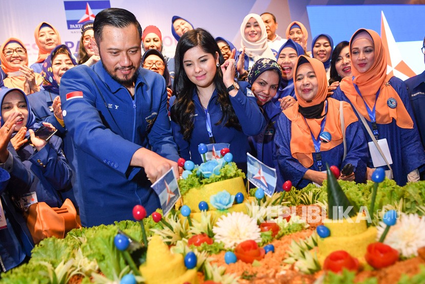 Ketua Umum Partai Demokrat yang baru, Agus Harimurti Yudhoyono (kiri) didampingi istri Annisa Pohan (kedua kiri) memotong tumpeng saat Kongres V Partai Demokrat di Jakarta, Ahad (15/3/2020).(Antara/M Risyal Hidayat)